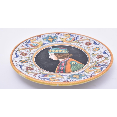 356 - A late 20th century Italian majolica plate / charger. The charger with side profile portrait of a yo... 