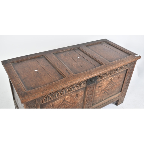 360 - A George III 18th century carved oak blanket box chest / coffer. The chest having a panelled hinged ... 