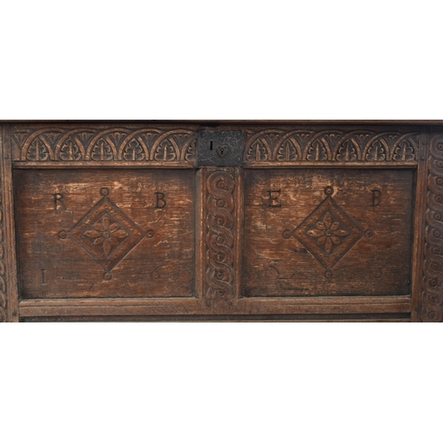 360 - A George III 18th century carved oak blanket box chest / coffer. The chest having a panelled hinged ... 