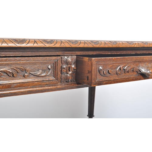 378 - A Victorian 19th century carved oak large writing table desk. The writing table having carved chamfe... 