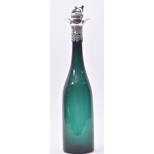 38 - An early Victorian 19th century silver hallmarked mounted green glass wine bottle. The bottle having... 