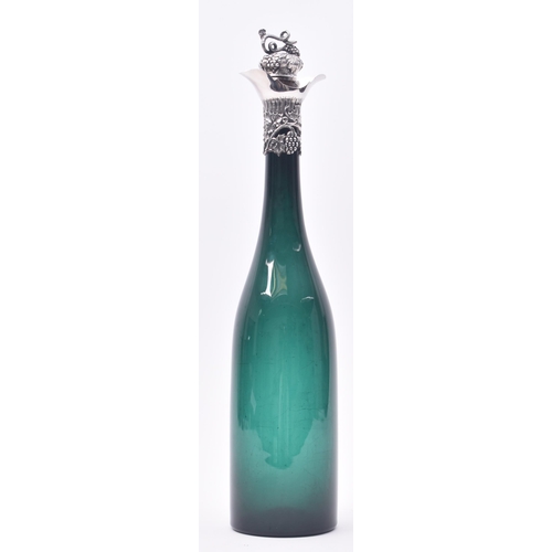 38 - An early Victorian 19th century silver hallmarked mounted green glass wine bottle. The bottle having... 