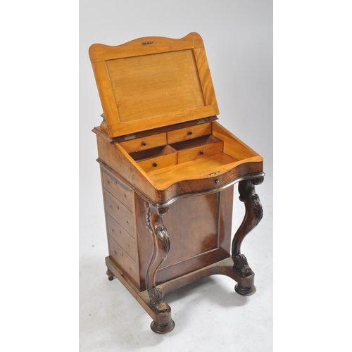 384 - A late 19th century Victorian walnut davenport writing bureau. The desk with inkwell stand shelf mou... 