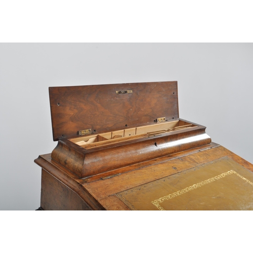 384 - A late 19th century Victorian walnut davenport writing bureau. The desk with inkwell stand shelf mou... 