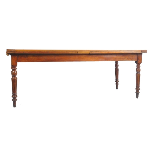 387 - A large Victorian 19th century walnut extending farmhouse refectory dining table. The table having a... 