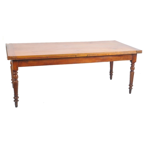 387 - A large Victorian 19th century walnut extending farmhouse refectory dining table. The table having a... 