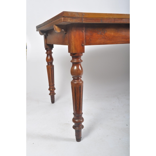 387 - A large Victorian 19th century walnut extending farmhouse refectory dining table. The table having a... 