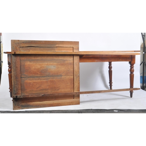 387 - A large Victorian 19th century walnut extending farmhouse refectory dining table. The table having a... 