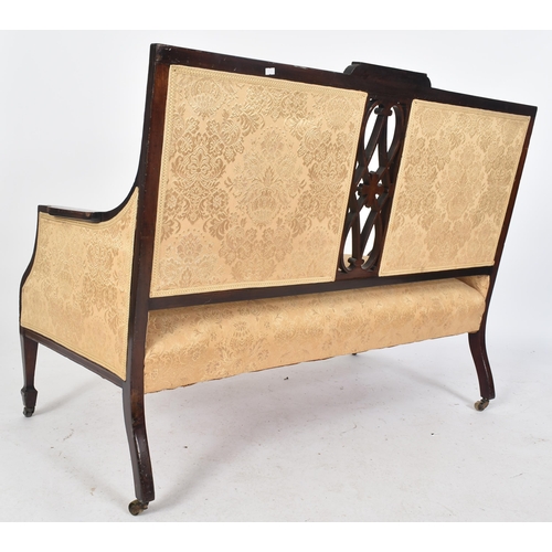 392 - An Edwardian mahogany inlaid two seater sofa settee / salon sofa. The sofa having a twin panel padde... 