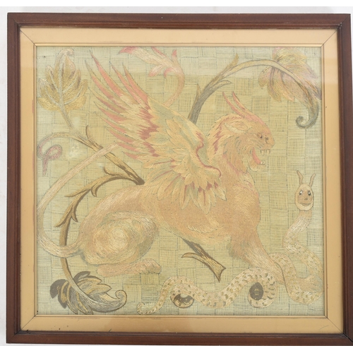 404 - A late 19th / early 20th century tapestry depicting a winged griffin slaying a snake. With bead deta... 