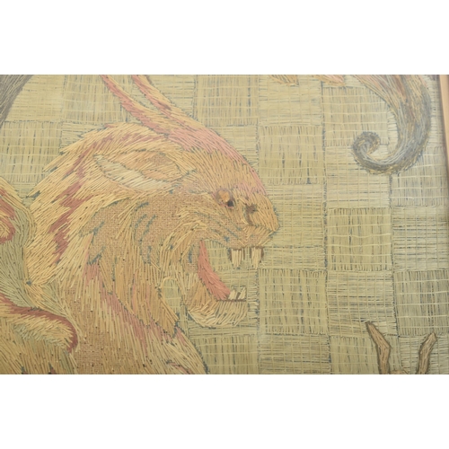 404 - A late 19th / early 20th century tapestry depicting a winged griffin slaying a snake. With bead deta... 