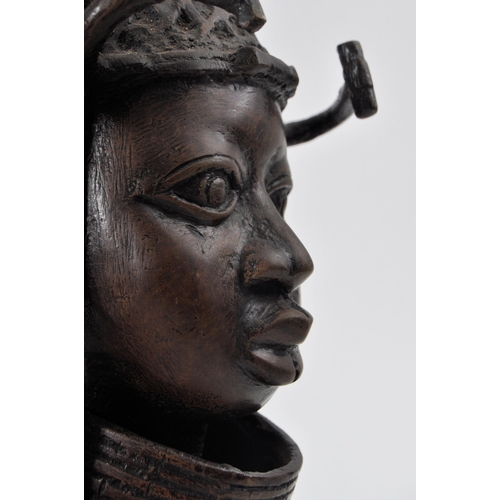 407 - A heavy 20th century African Benin cast bronze figure of a native warrior. The bust wearing a headdr... 