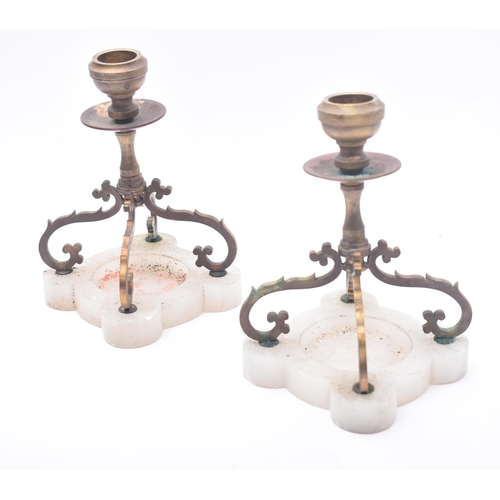 423 - A pair of early 20th century brass & onyx base table desk candlestick holders. Each candlestick havi... 