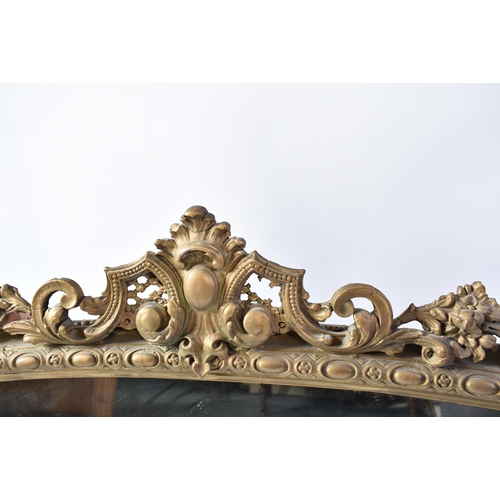 424 - A Victorian 19th century gilt wood & gesso over mantle mirror. The mirror having an intricate embell... 