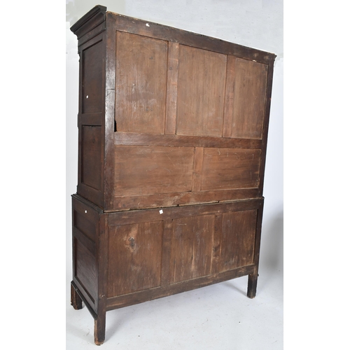 425 - An 18th century George III oak country house housekeeper's cupboard / linen press. The cupboard comp... 