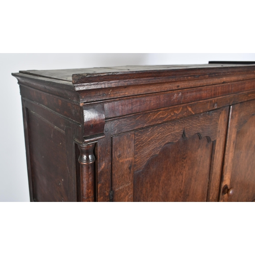 425 - An 18th century George III oak country house housekeeper's cupboard / linen press. The cupboard comp... 