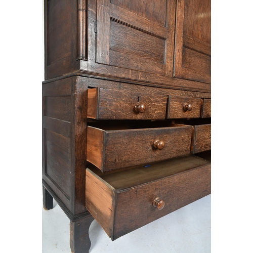 425 - An 18th century George III oak country house housekeeper's cupboard / linen press. The cupboard comp... 