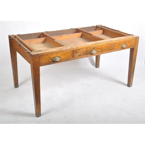 439 - An early 20th century railway / government oak writing table desk. Raised on square tapering legs wi... 