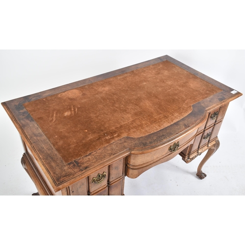 442 - An early 20th century Queen Anne revival burr walnut inverted breakfront writing desk / table. The d... 