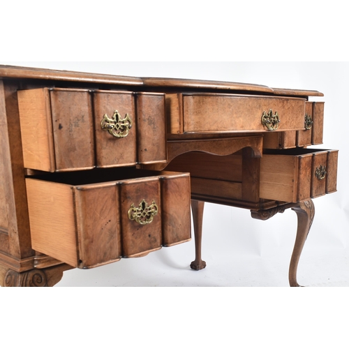 442 - An early 20th century Queen Anne revival burr walnut inverted breakfront writing desk / table. The d... 