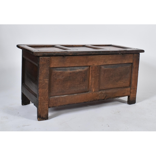 454 - A 17th century inlaid oak coffer / blanket box / chest. The coffer having a hinged top over a carved... 