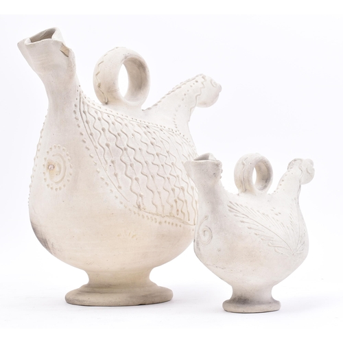 457 - In the Manner of Jean Derval - A near pair of continental 20th century pottery pitcher jugs of bird ... 