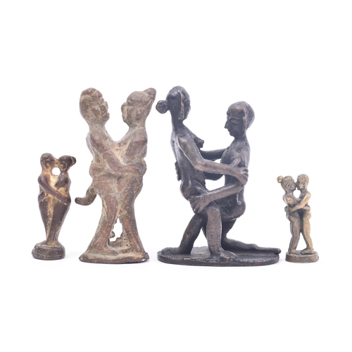 467 - A collection of four 19th century tribal style erotic bronze / iron figurines depicting pairs of lov... 