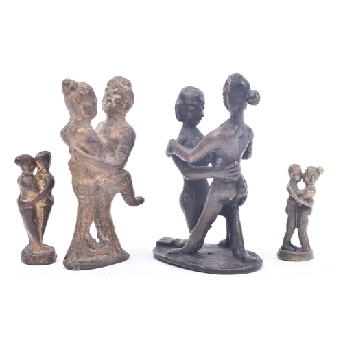 467 - A collection of four 19th century tribal style erotic bronze / iron figurines depicting pairs of lov... 