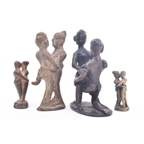 467 - A collection of four 19th century tribal style erotic bronze / iron figurines depicting pairs of lov... 