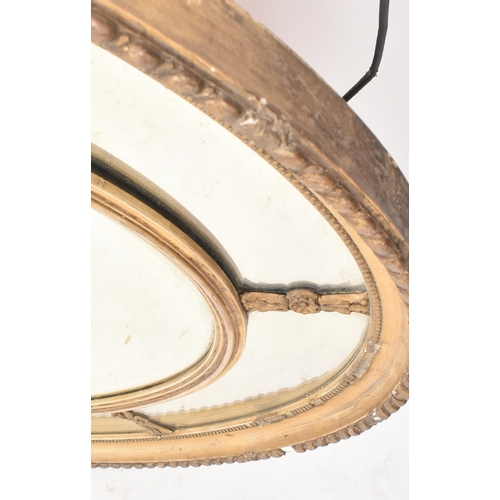 47 - A 19th century Victorian oval giltwood and gesso mirror. The mirror having a gilt frame with gadroon... 