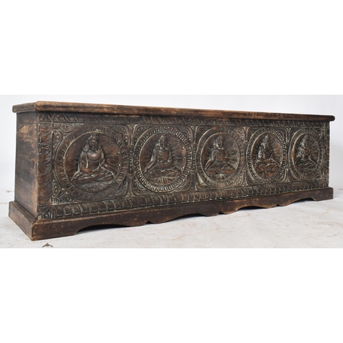 475 - A large 20th century Southeast Asian heavily carved hardwood coffer box. The coffer having a hinged ... 