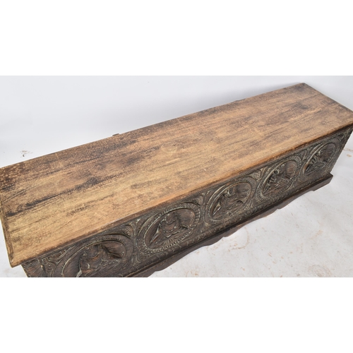 475 - A large 20th century Southeast Asian heavily carved hardwood coffer box. The coffer having a hinged ... 