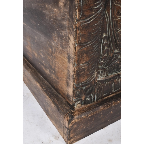 475 - A large 20th century Southeast Asian heavily carved hardwood coffer box. The coffer having a hinged ... 