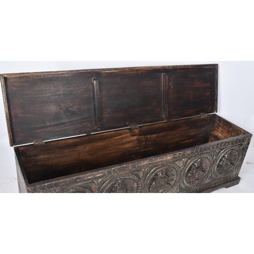 475 - A large 20th century Southeast Asian heavily carved hardwood coffer box. The coffer having a hinged ... 