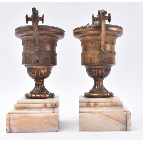 480 - A pair of 19th century French Empire style gilt bronze urns. Each urn of classical form with scrolle... 