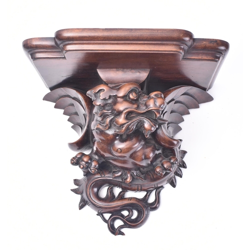 51 - A 19th century French carved hardwood in the shape of a dragon wall bracket. The bracket having a br... 