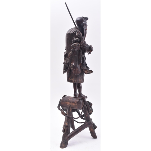 636 - A 19th century Japanese carved root wood figure of a fisherman. The carving stood upright with rod o... 