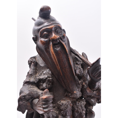 636 - A 19th century Japanese carved root wood figure of a fisherman. The carving stood upright with rod o... 