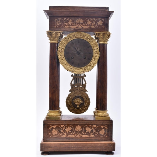 64 - A 19th century continental French rosewood & mahogany inlay Portico mantel clock. The clock having a... 