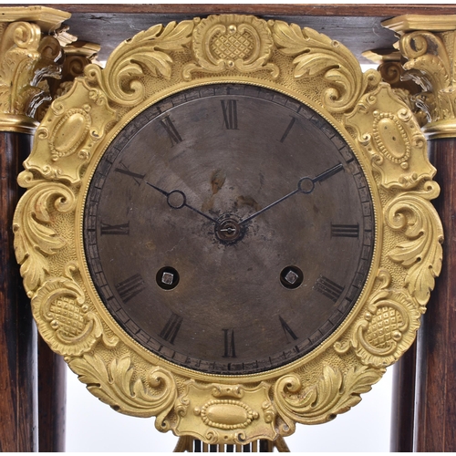 64 - A 19th century continental French rosewood & mahogany inlay Portico mantel clock. The clock having a... 