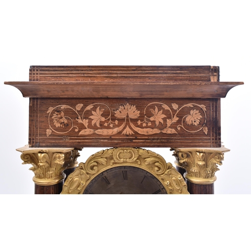 64 - A 19th century continental French rosewood & mahogany inlay Portico mantel clock. The clock having a... 