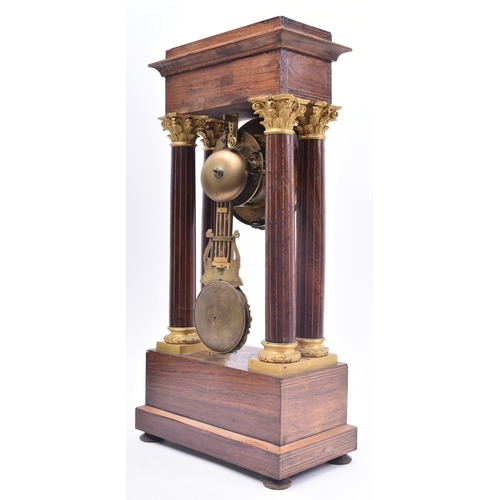 64 - A 19th century continental French rosewood & mahogany inlay Portico mantel clock. The clock having a... 