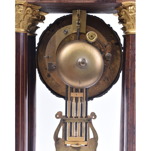 64 - A 19th century continental French rosewood & mahogany inlay Portico mantel clock. The clock having a... 