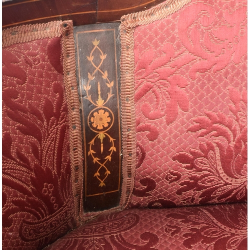 644 - An Edwardian mahogany inlaid framed two seater salon sofa / settee. The sofa having a shaped padded ... 