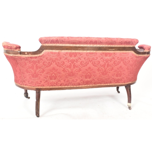 644 - An Edwardian mahogany inlaid framed two seater salon sofa / settee. The sofa having a shaped padded ... 