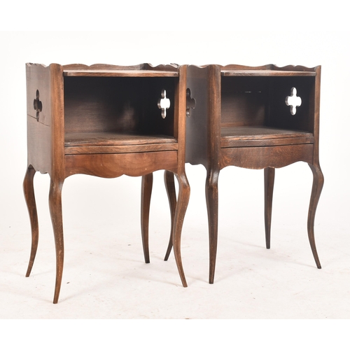 645 - A pair of early 20th century French oak nightstands / bedside tables. Each having shaped gallery sur... 