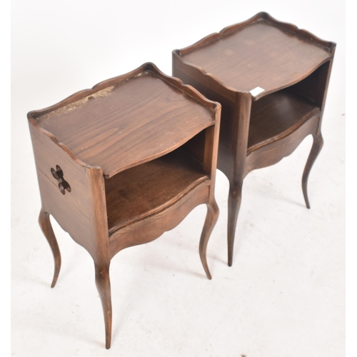 645 - A pair of early 20th century French oak nightstands / bedside tables. Each having shaped gallery sur... 