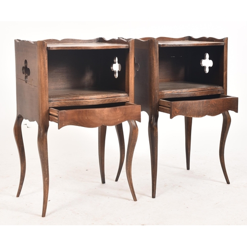 645 - A pair of early 20th century French oak nightstands / bedside tables. Each having shaped gallery sur... 