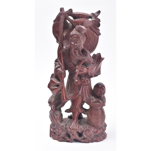 653 - A 19th century Chinese carved wooden fisherman & boy. The carving with basket, bird & boy. Believed ... 