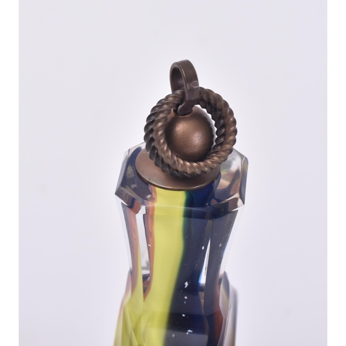 659 - A 20th century multicoloured cased glass flask / bottle. Small pair of picks to the copper cover wit... 